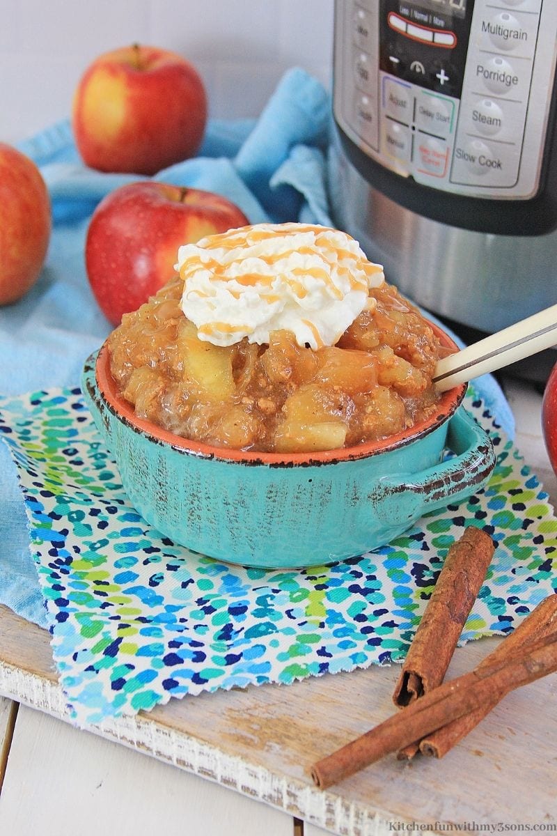 Instant Pot Cinnamon Apples Recipe in a serving bowl topped with whipped cream.