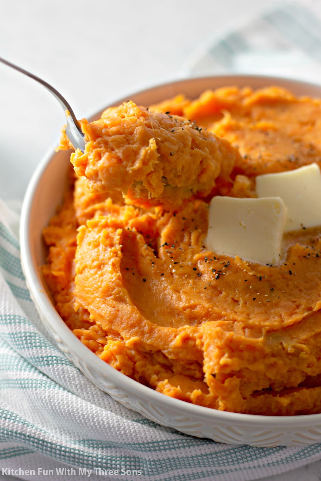 scooping Mashed Sweet Potatoes with a spoon