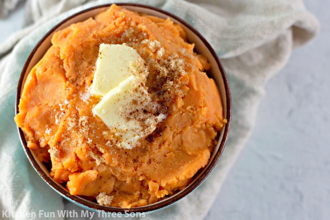 Mashed Sweet Potatoes in a bowl topped with butter