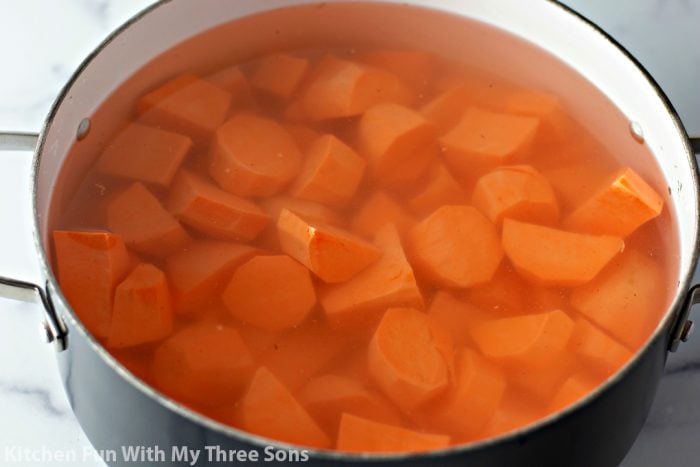 Sweet potato chunks boiling in a pot of water