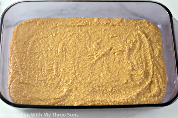 peanut butter bars spread in a Pyrex dish