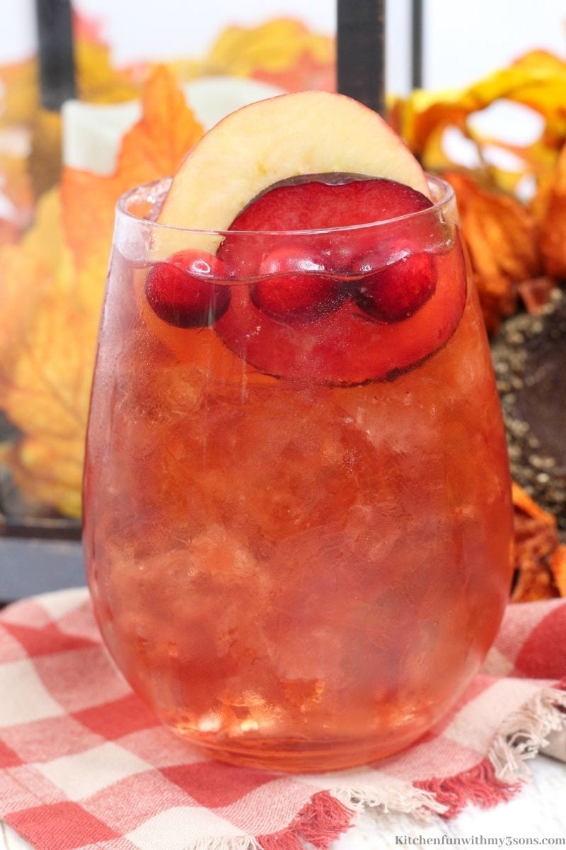 Plum Apple Hot Toddy Whiskey Drink garnished with plums and apples.
