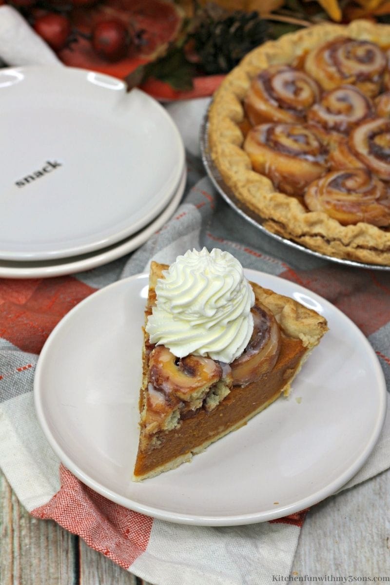 Pumpkin Cinnamon Roll Pie topped with whipped cream.