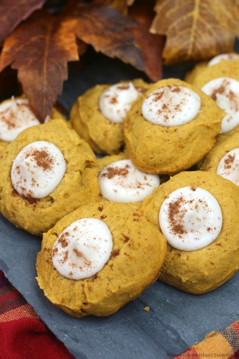 Pumpkin Thumbprint Cookies on a cloth with leaves behind it.