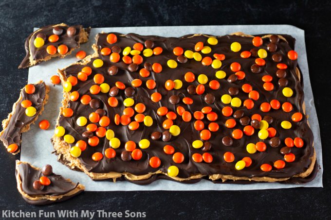breaking Reese's Peanut Butter Chocolate Bark into pieces