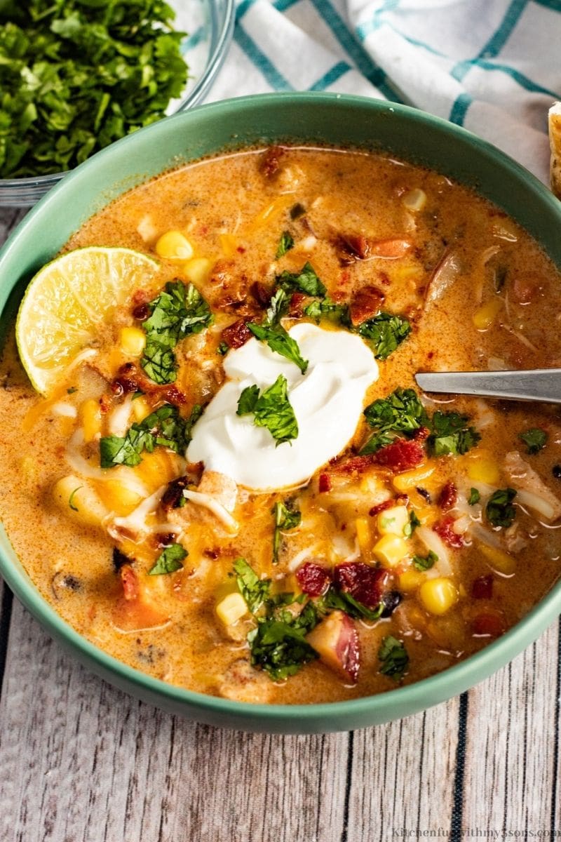 Southwest Chicken Corn Chowder with a lime and side of cilantro.