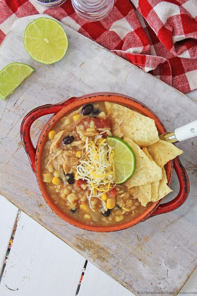 Tex Mex Instant Pot Chicken and Rice Soup with chips added with a lime next to it.