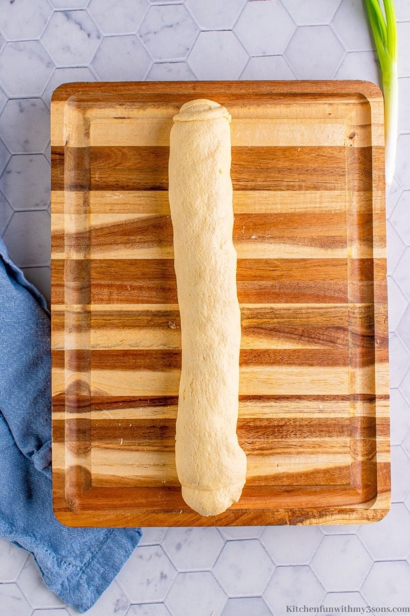 The dough tightly wrapped into a log.