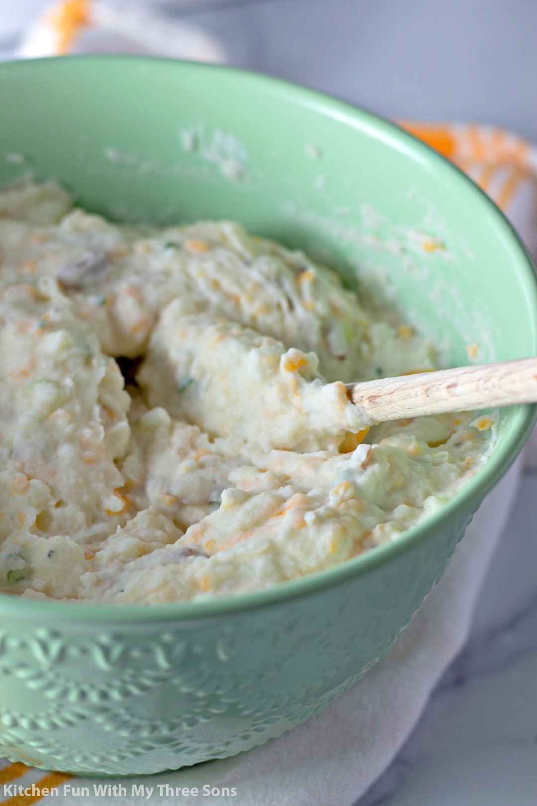 Loaded mashed potatoes in a green bowl