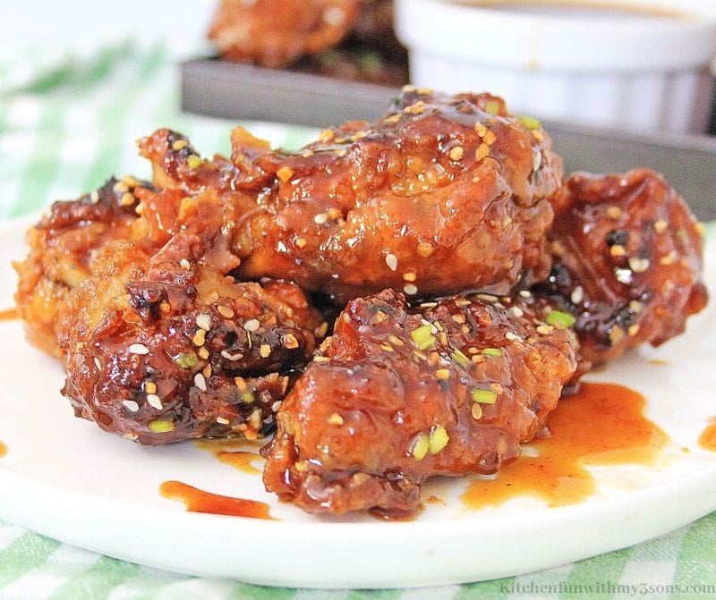 Up close Air Fryer Korean BBQ Chicken Wings with more sauce behind it.