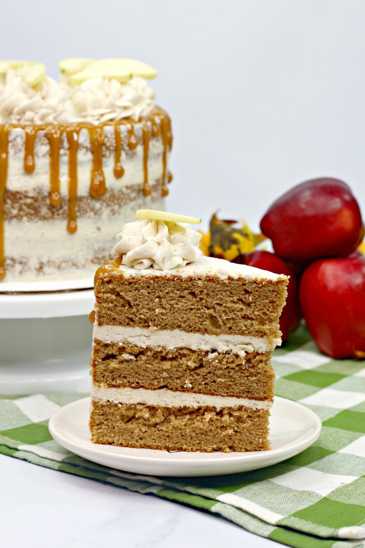 slice of layered apple spice cake on a white plate