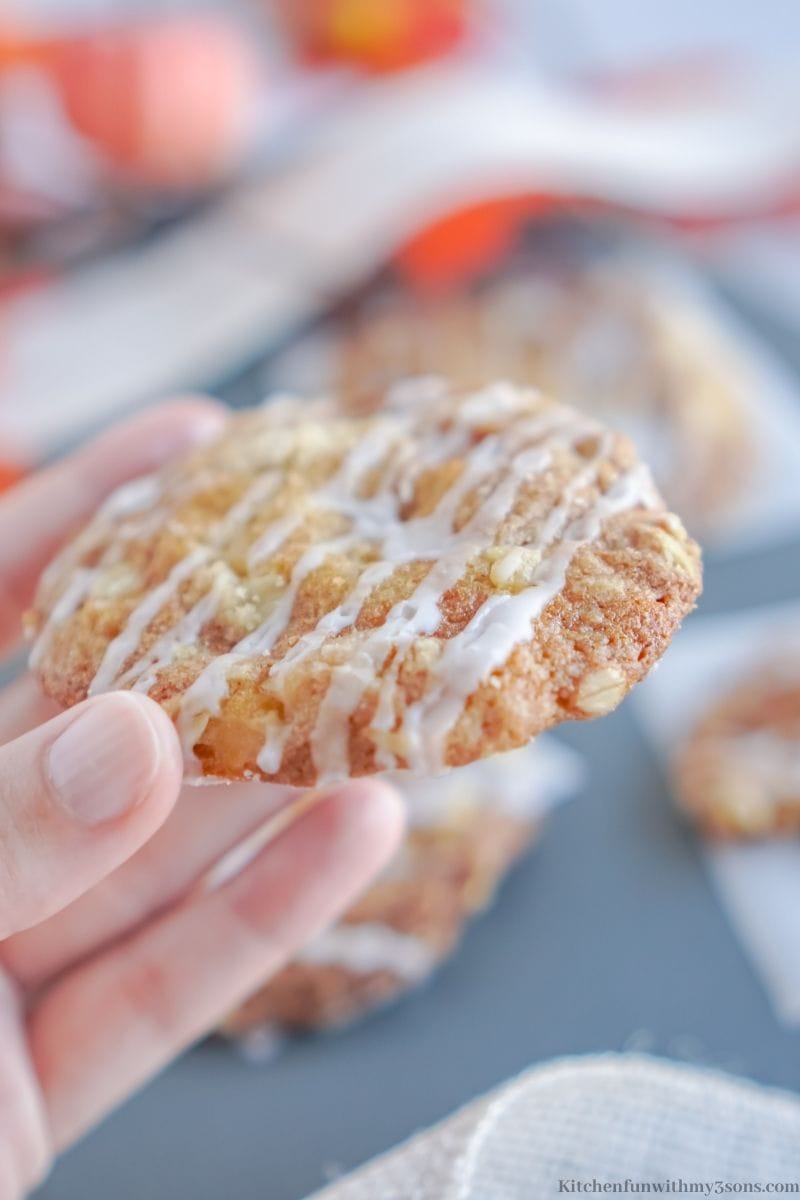 A hand holding up one of the Caramel Apple Crisp Cookies.