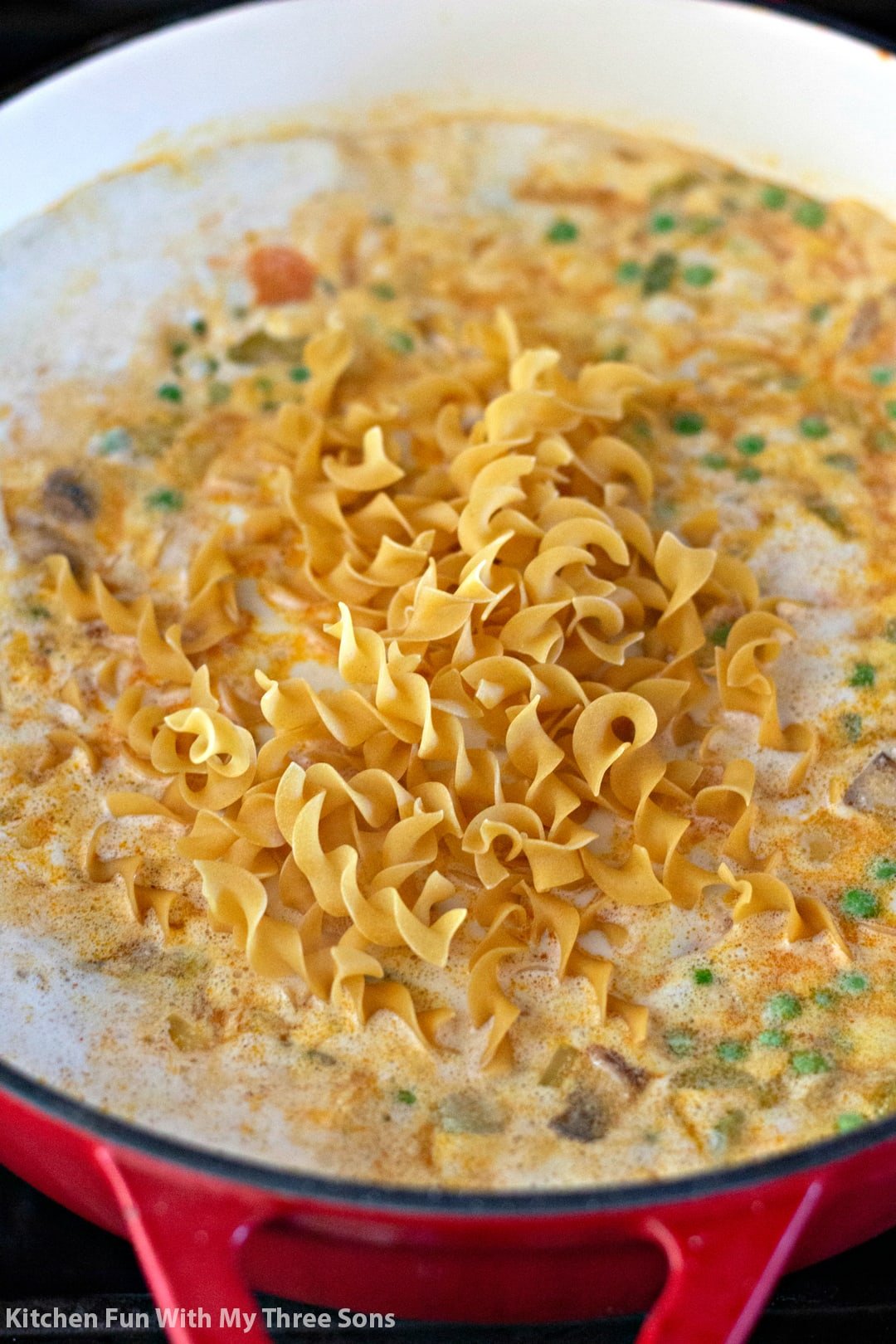 Egg noodles are added into simmering Chicken Pot Pie Soup.