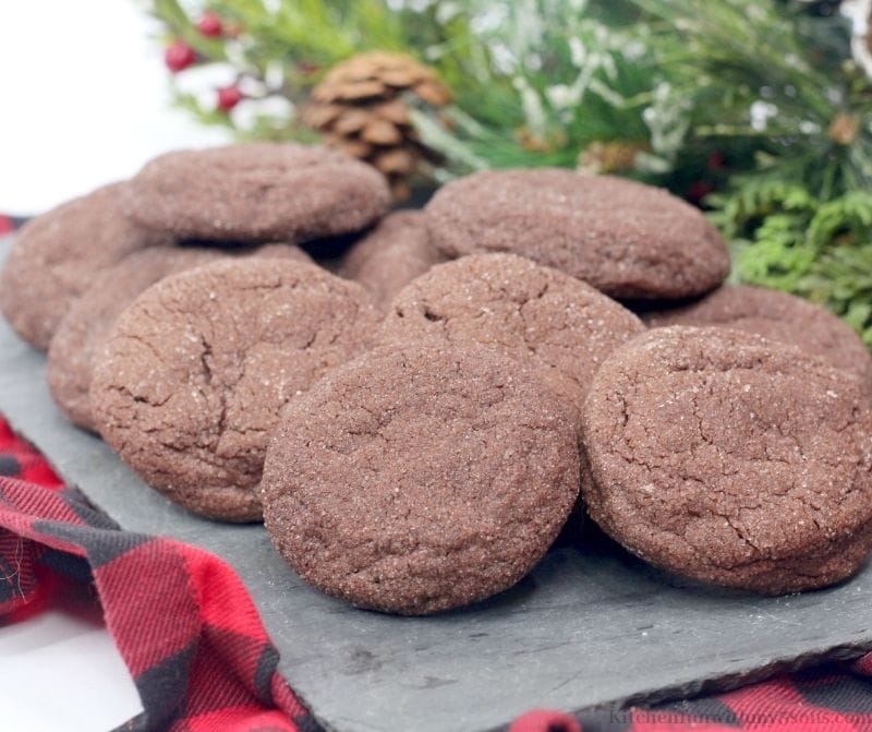 Chocolate Snickerdoodles on a gray slate on top of a flannel cloth.