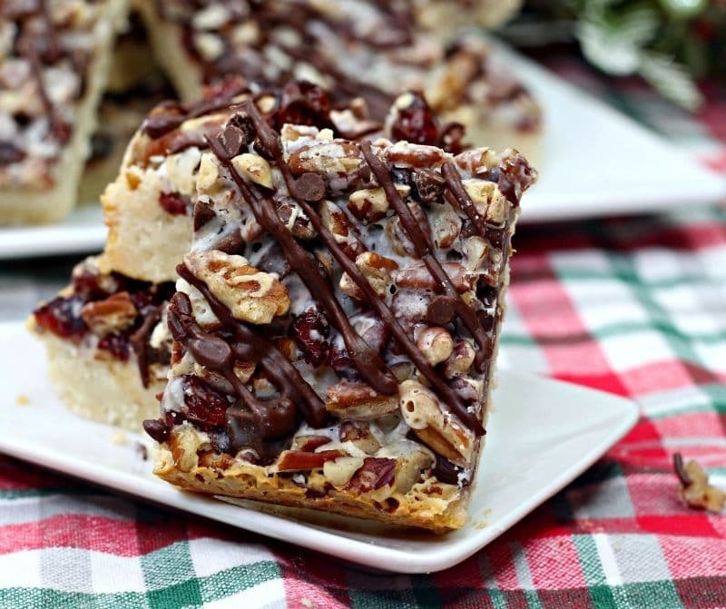 Dark Chocolate Cranberry Magic Bars on a patterned cloth.