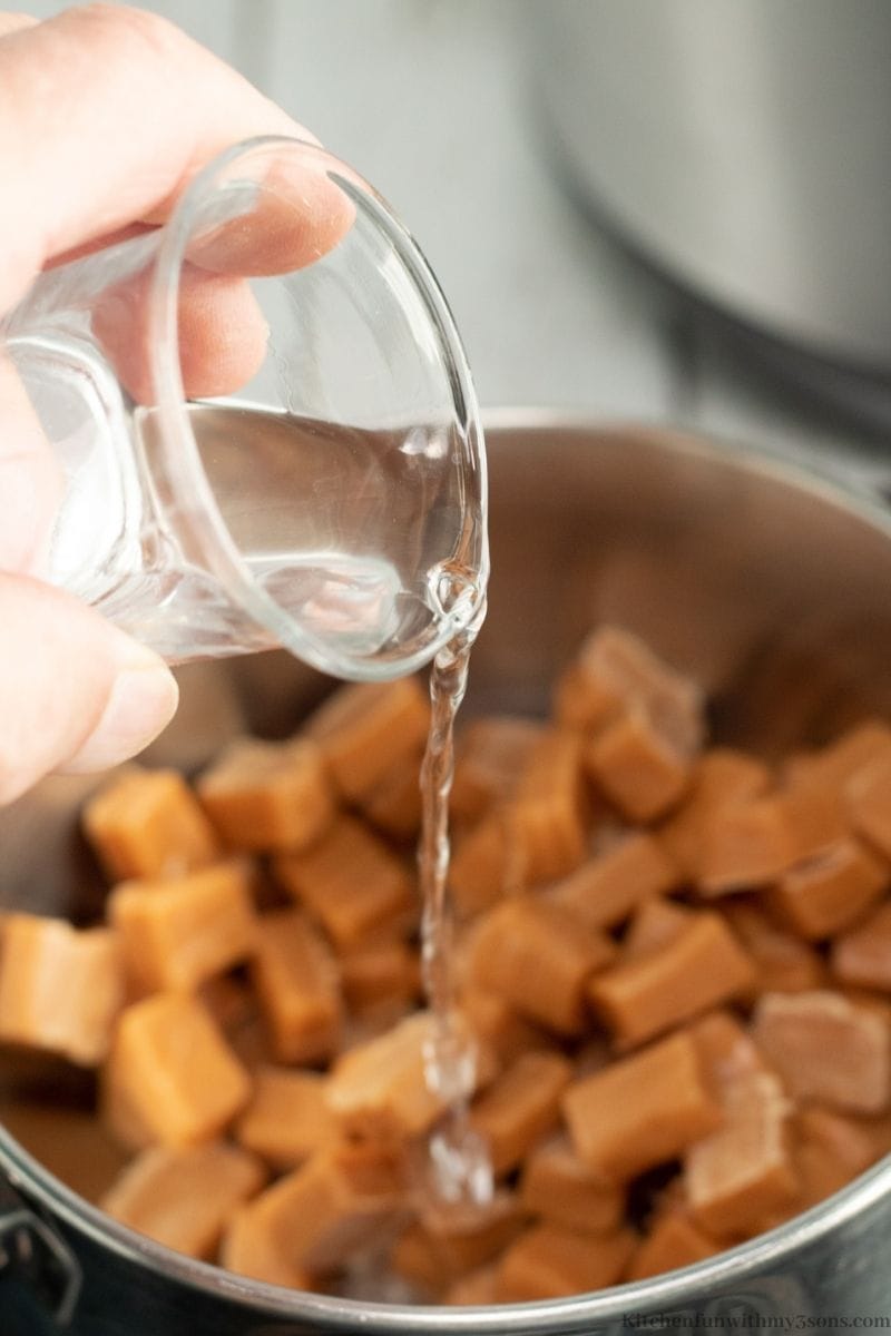 Adding water to your caramel to begin melting.