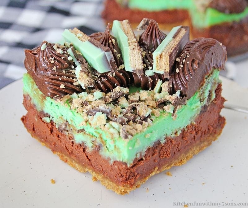 An up close image of one slice of the Kit Kat Chocolate Mint Cheesecake.