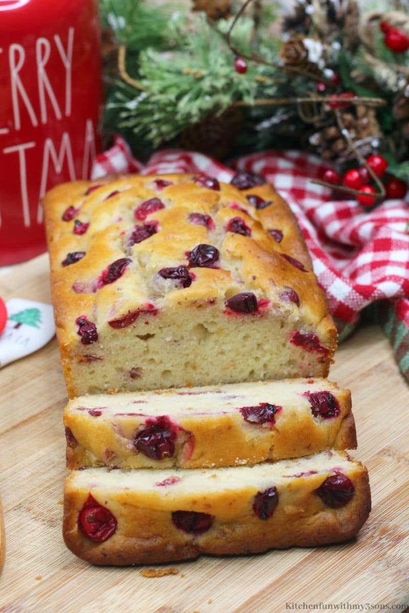 Orange Cranberry Bread with a Christmas jar behind it.
