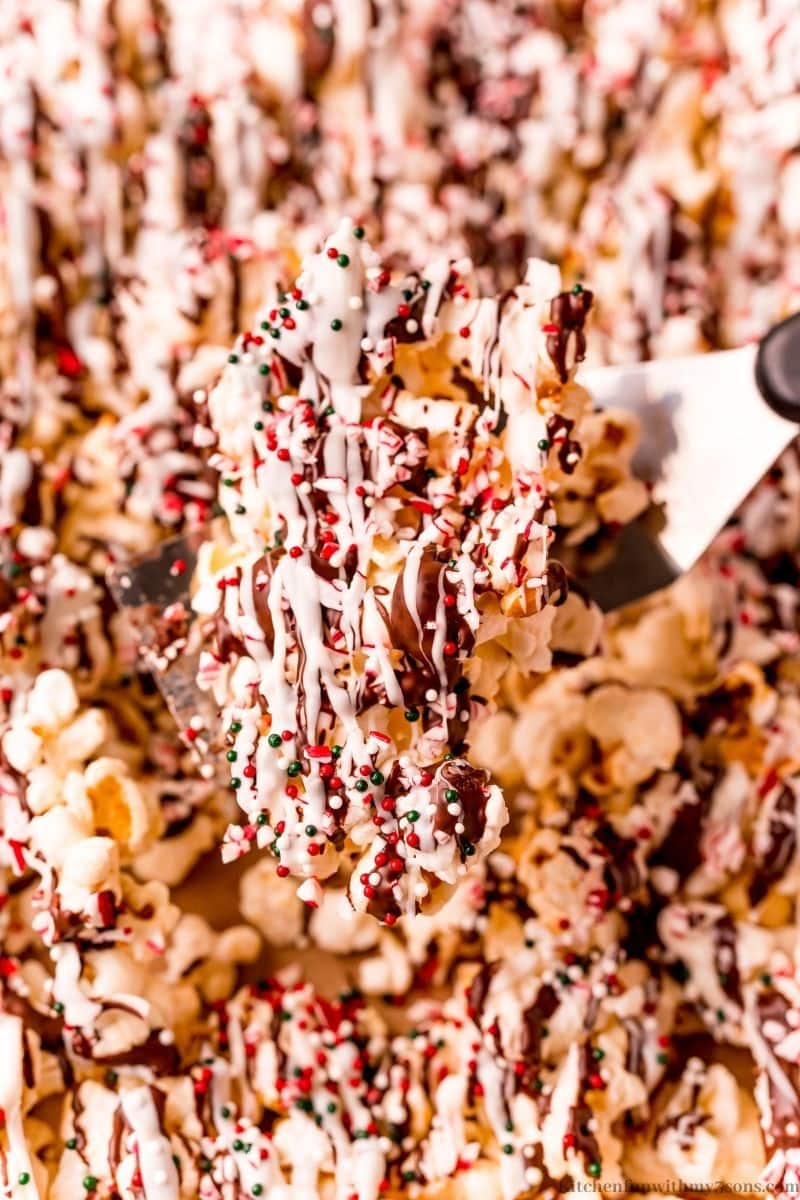 A spatula lifting up some of the Peppermint bark popcorn.