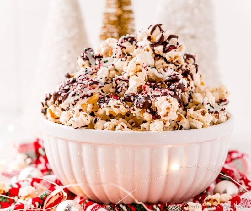 Peppermint bark popcorn with lights around it.