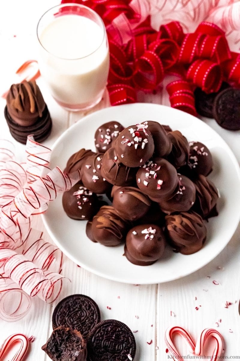 Peppermint Oreo Truffles served with a glass of milk.