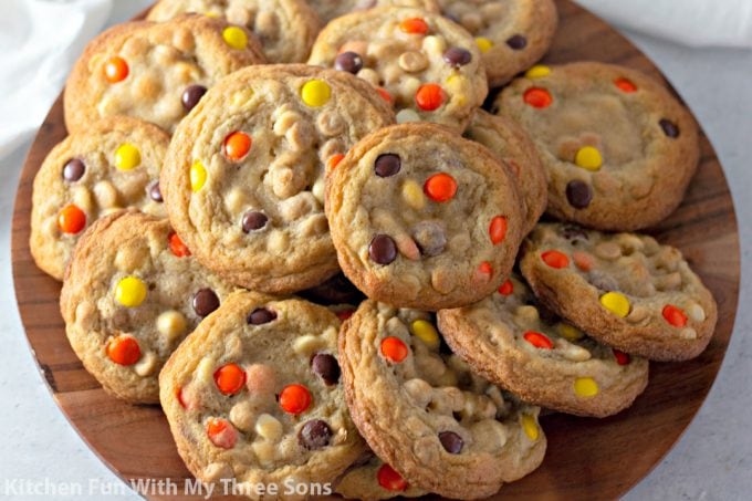 Reese's Pieces Cookies on a wooden platter