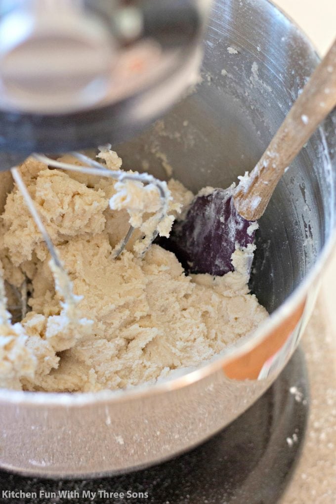mixing cookie dough in a metal mixing bowl