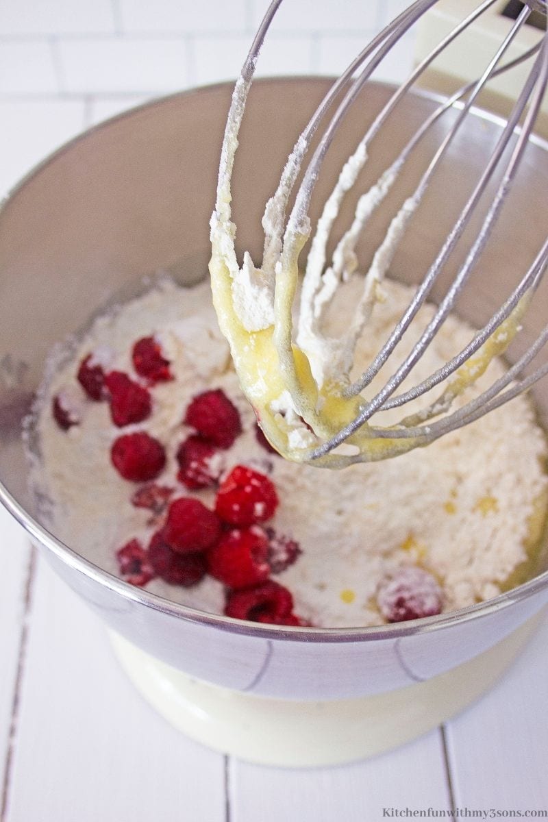 Fresh raspberries being folded into the batter.