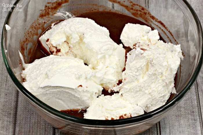 A mixture of milk, rum, instant coffee and chocolate pudding in a glass bowl with Cool Whip on top