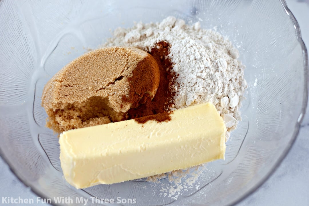 Flour, brown sugar, vanilla, and a stick of butter in a mixing bowl
