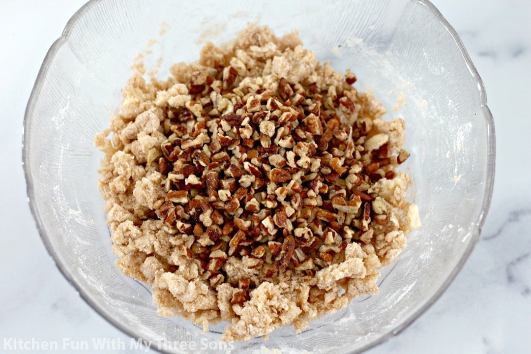 Chopped pecans, butter, and sugar in a mixing bowl