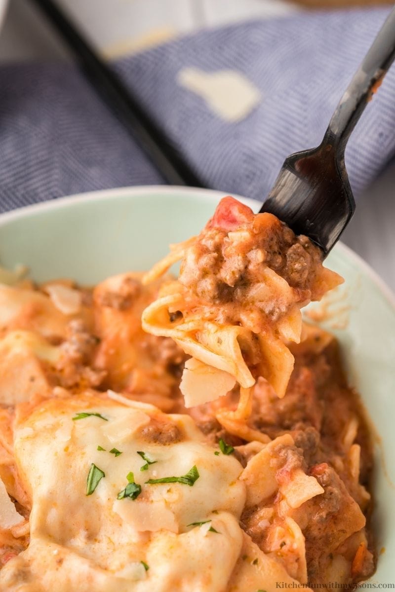 A fork lifting up the The Easiest Skillet Lasagna Recipe out of a serving bowl.