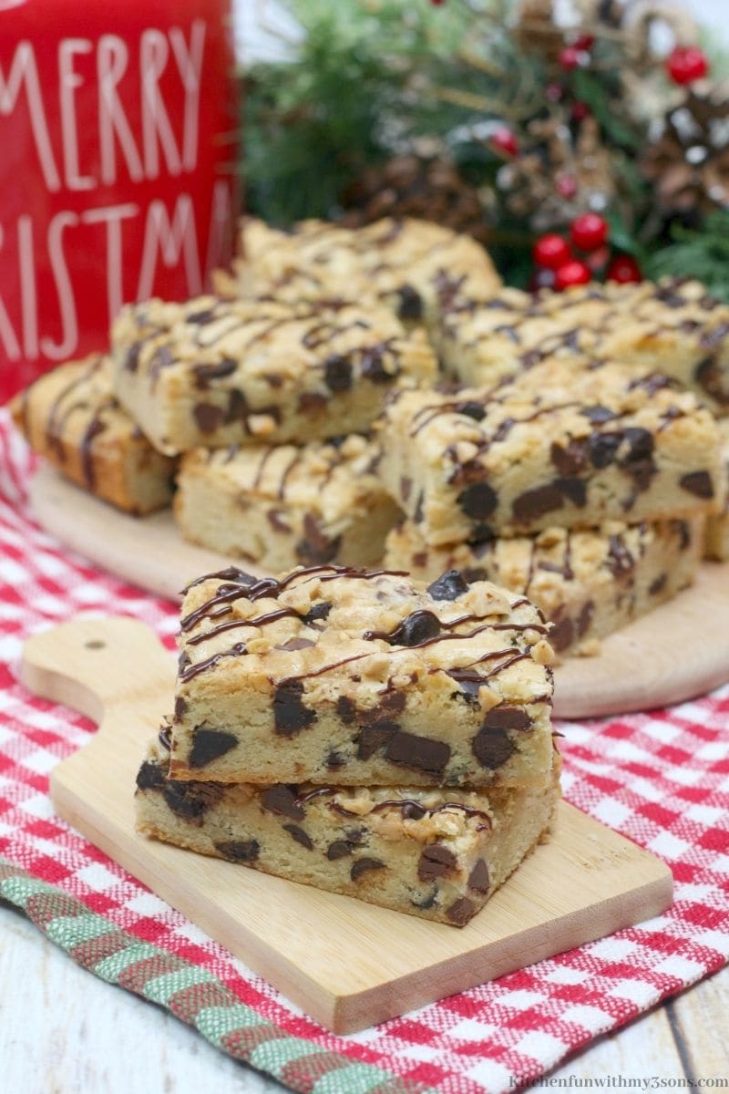 Toffee Cookie Bars with a checkered cloth underneath it with snow frosted decorations in the back.