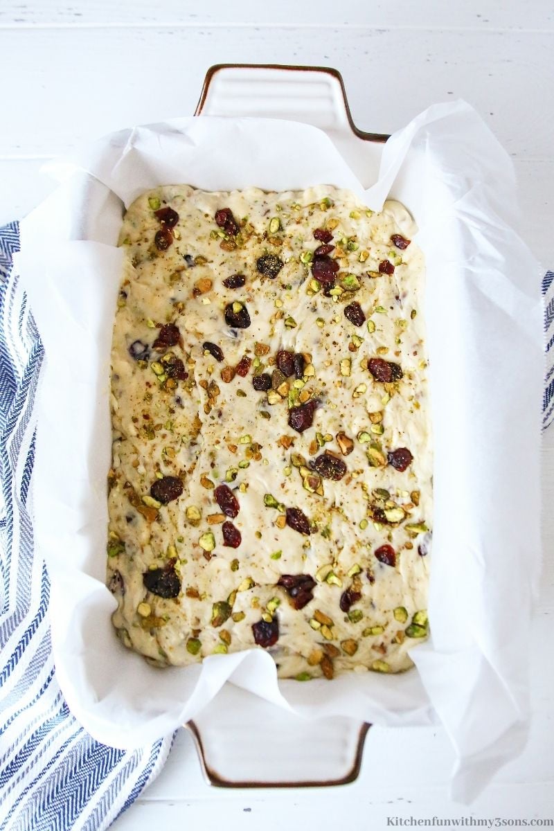 Sprinkling the rest of the pistachios and cranberries on top.