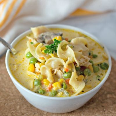 A bowl of hearty and creamy Chicken Pot Pie Soup with Noodles.