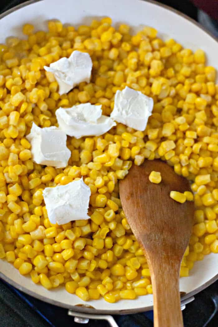 slices of cream cheese on corn kernels