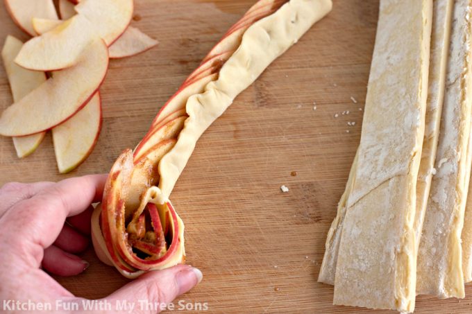 rolling the apple filled pastry into roses