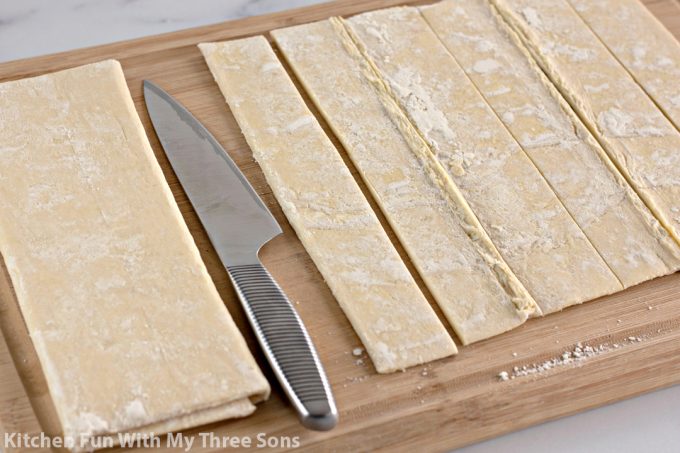 cutting strips of puff pastry