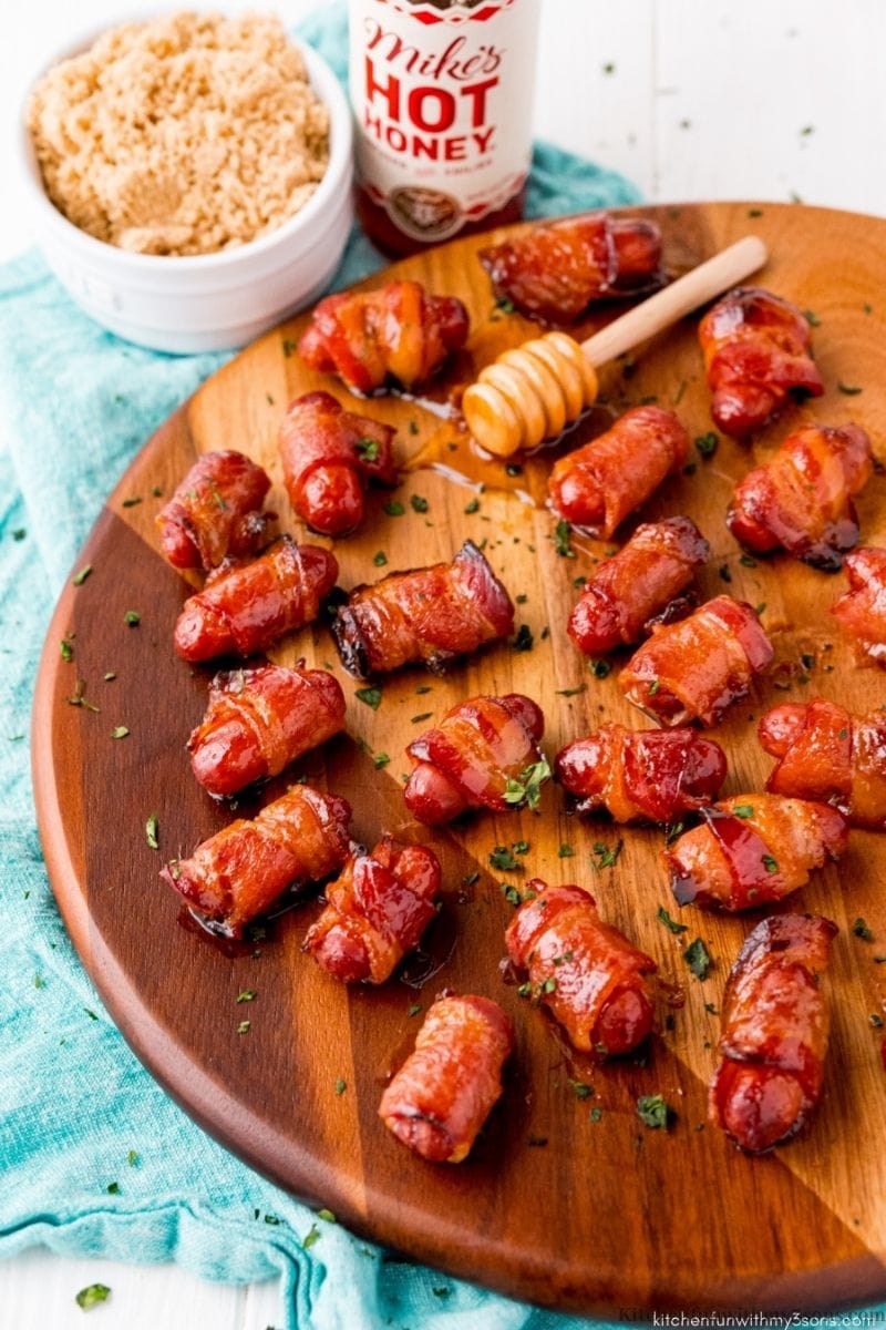 Bacon-Wrapped Smokies on a circle wooden board.
