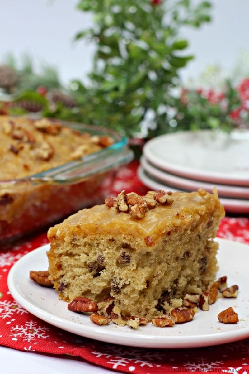 Butter Pecan Sheet Cake with leafed decorations behind it.