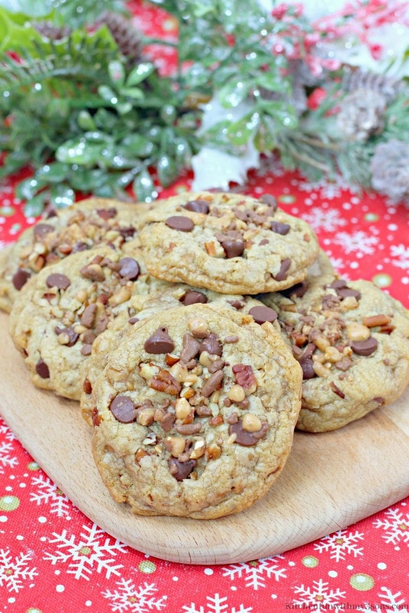 Chocolate Chip Pecan Toffee Cookies on a wooden board.