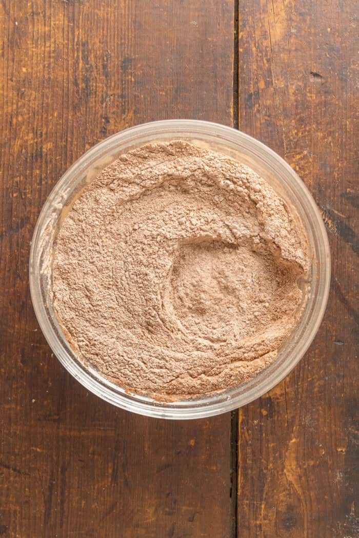 These Chocolate Peppermint Cookies are loaded with semi-sweet, white, and dark chocolate plus crushed peppermint. Soft & chewy! Dry cookie ingredients in a bowl