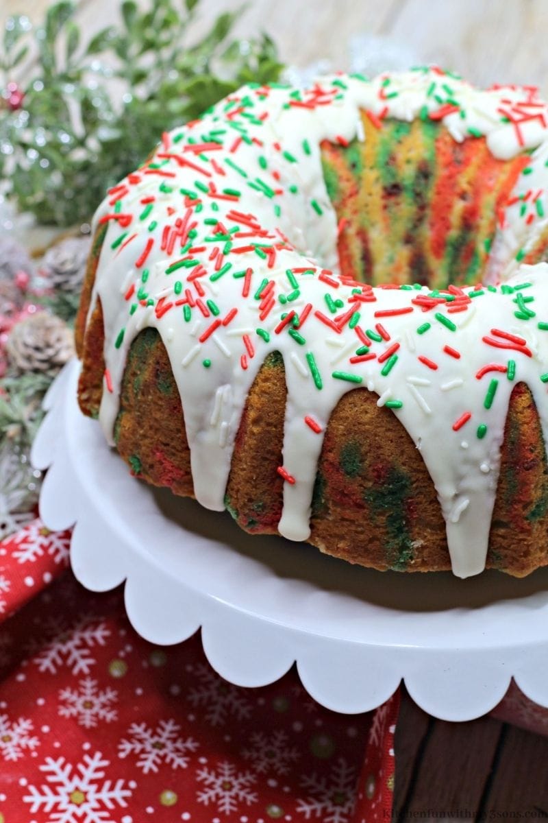 The whole Christmas Funfetti Bundt Cake on a standing platter.