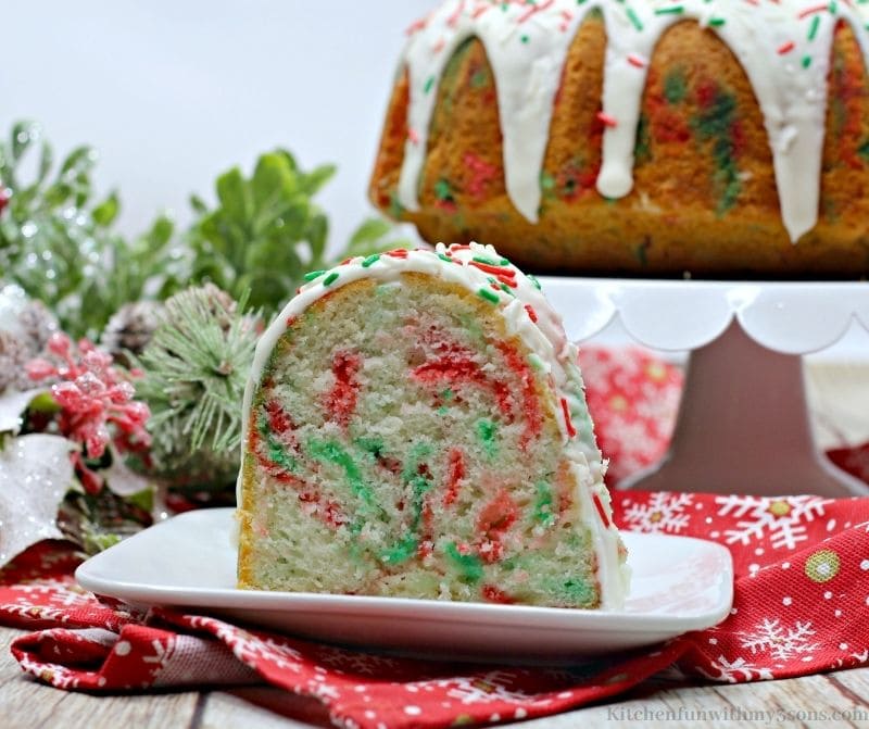 A slice of the Christmas Funfetti Bundt Cake on a serving plate.