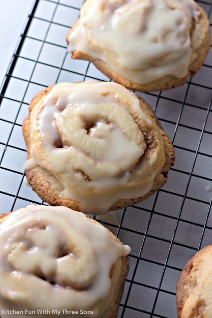 Frosted Cinnamon Roll Cookies on a wire cooling rack