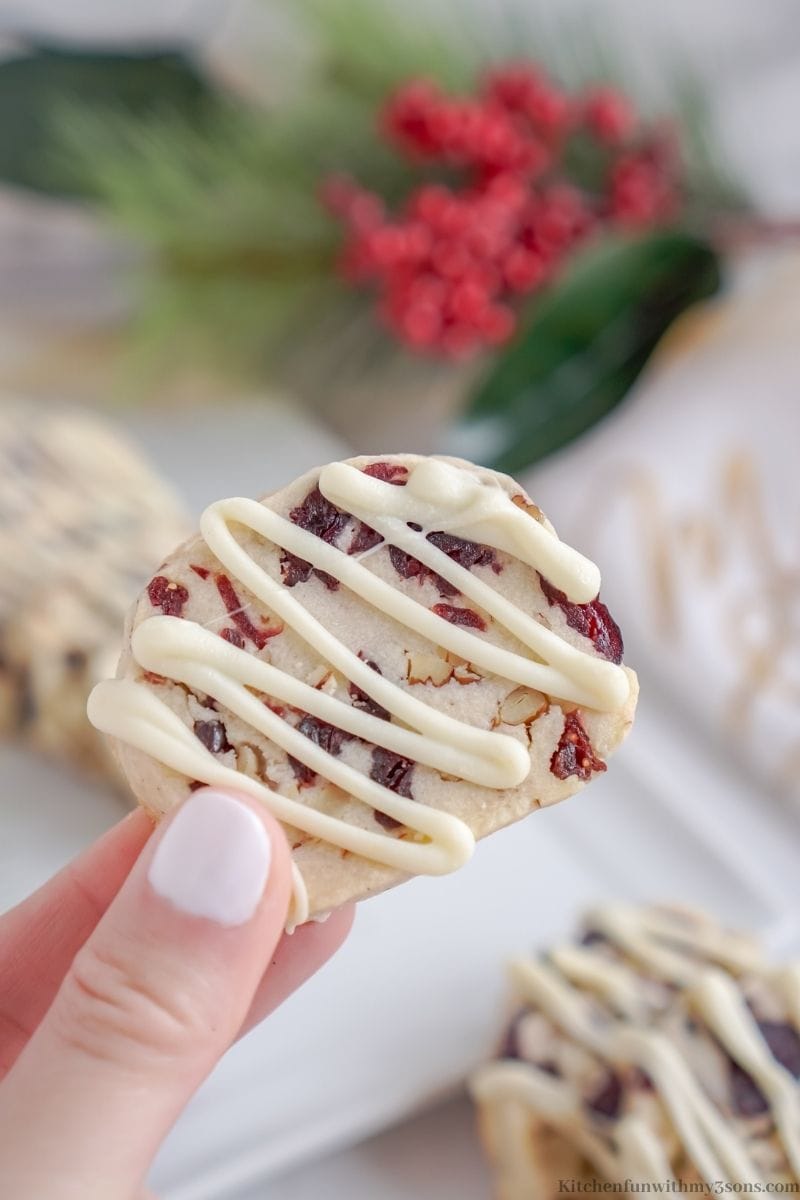 A hand holding one of the Cranberry Shortbread Cookies.