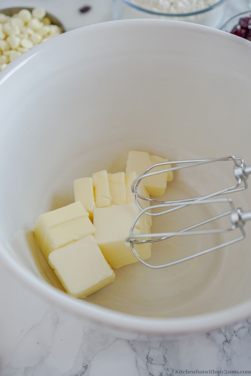 Adding the butter into the bowl to start the batter.