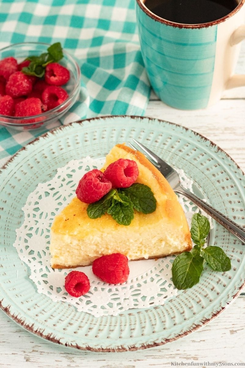 Crème Brule Cheesecake topped with raspberries and mint.