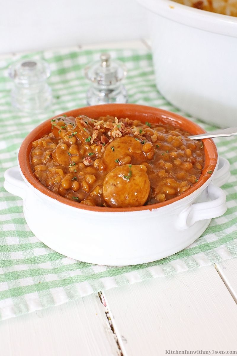 Crock-Pot Kielbasa Sausage and Beans Recipe on a green cloth, on a white table.