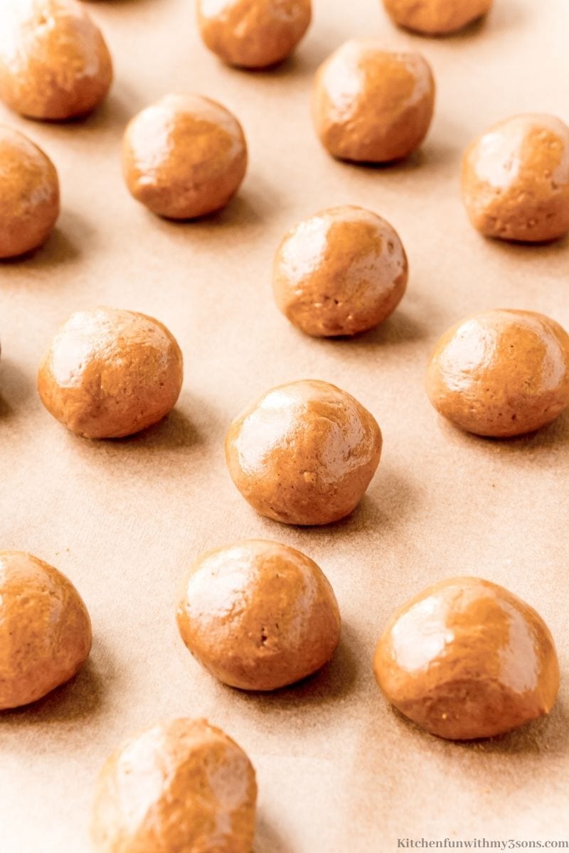 Adding the dough balls into the cookie sheets.